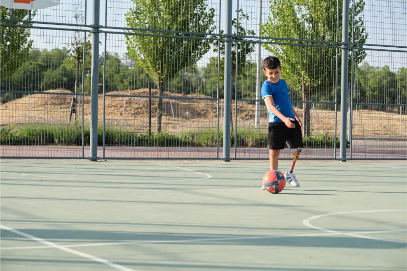 a kid with a leg prosthesis playing football chil 2023 11 27 05 03 44 utc